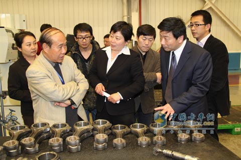 中国汽车工业协会专家委员会常务副主任晏一平(左一)在听潍柴介绍再制造情况